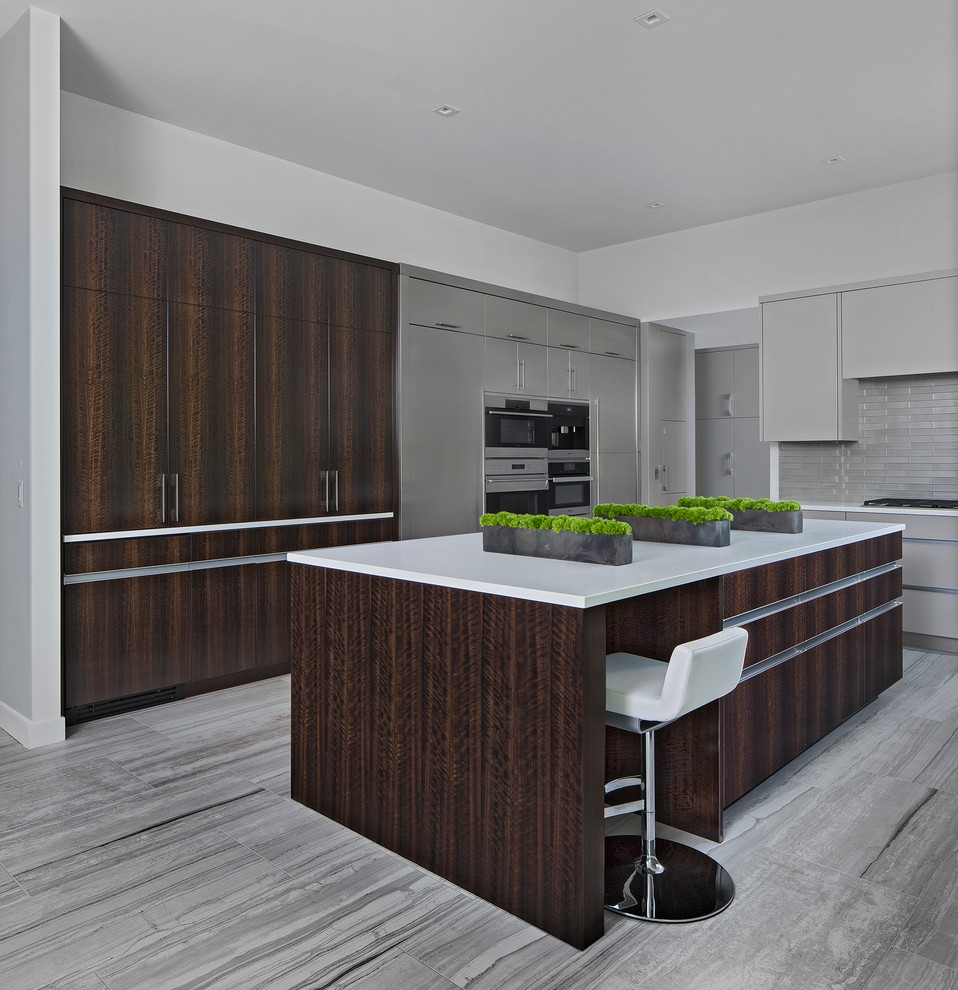 Enclosed kitchen - contemporary enclosed kitchen idea in Detroit with gray cabinets and an island