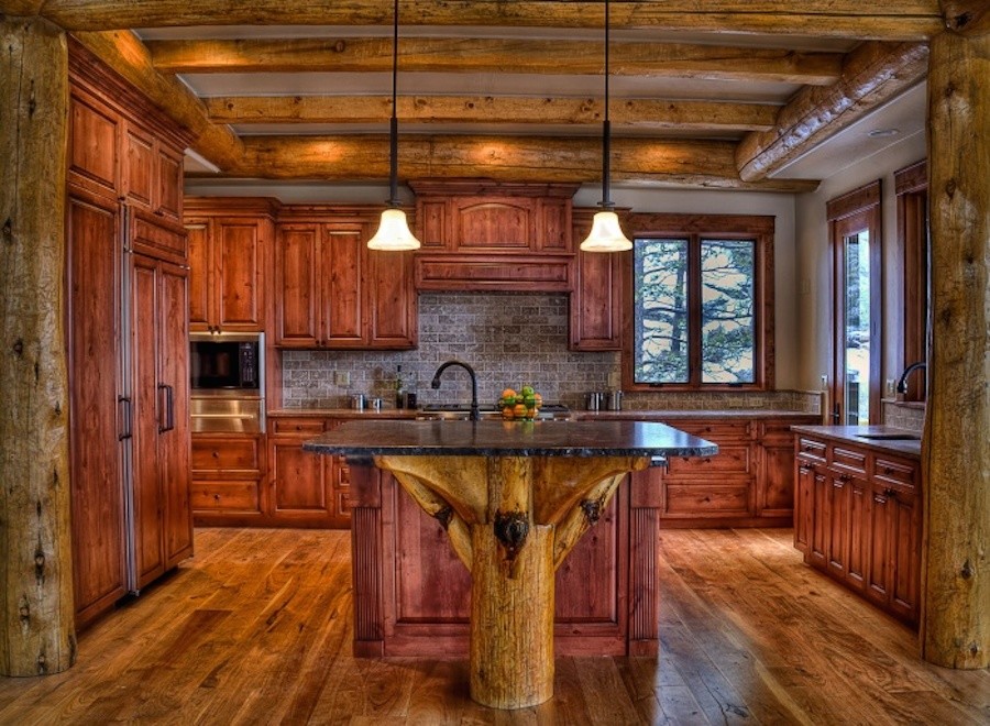 Large rustic u-shaped enclosed kitchen in Denver with a built-in sink, louvered cabinets, medium wood cabinets, granite worktops, grey splashback, integrated appliances, medium hardwood flooring and an island.