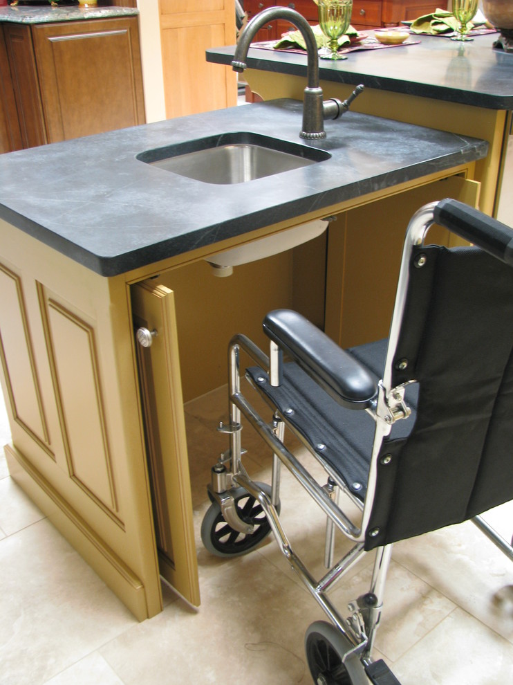 This is an example of a traditional kitchen/diner in Denver with a submerged sink, raised-panel cabinets, beige cabinets, onyx worktops, stainless steel appliances, ceramic flooring and an island.