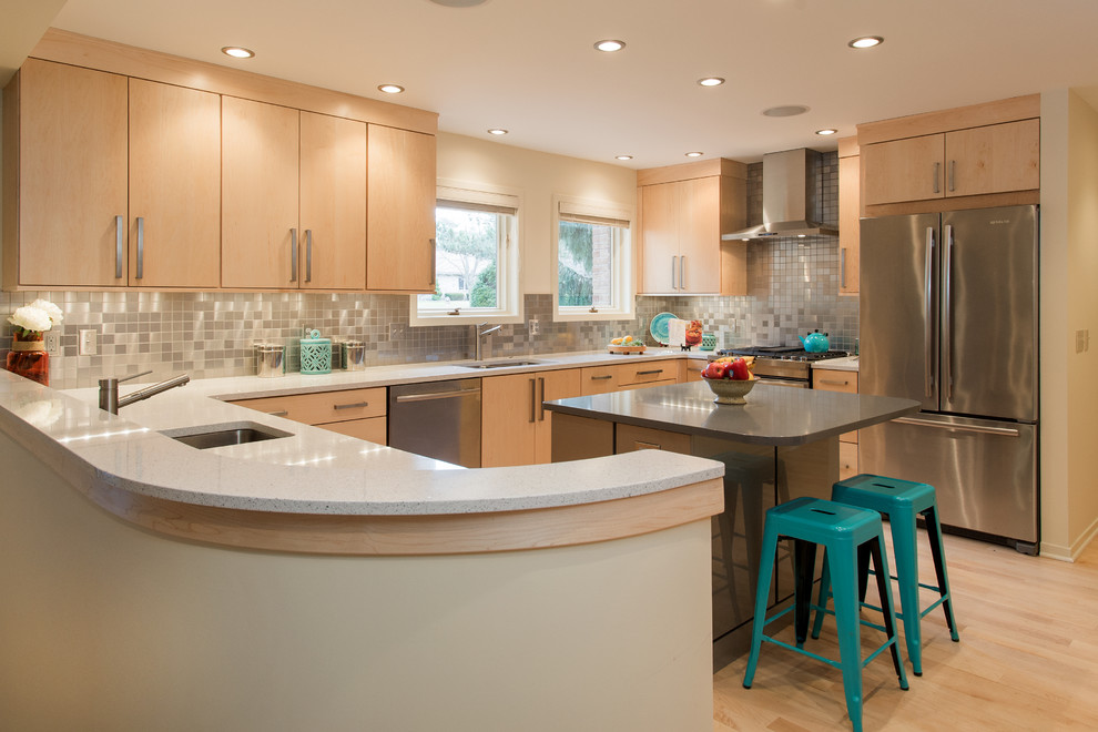 Inspiration for a large contemporary u-shaped light wood floor eat-in kitchen remodel in Grand Rapids with an undermount sink, flat-panel cabinets, light wood cabinets, quartz countertops, metallic backsplash, metal backsplash, stainless steel appliances and an island