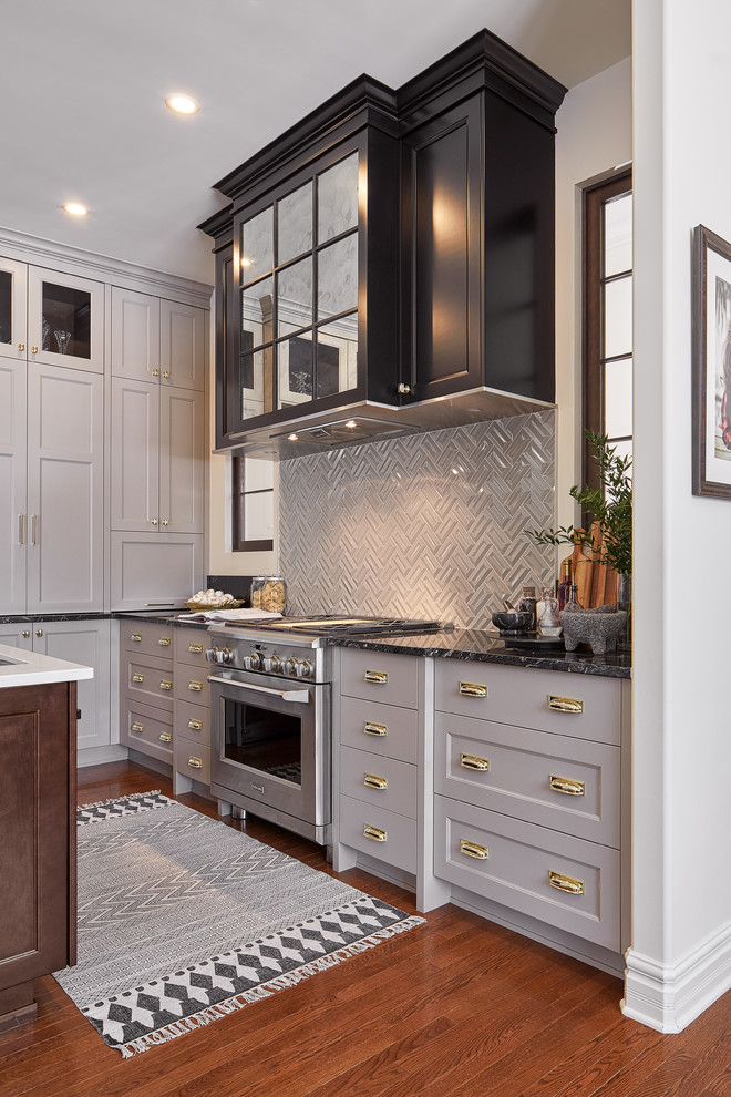 Mid-sized elegant l-shaped medium tone wood floor open concept kitchen photo in Ottawa with an undermount sink, shaker cabinets, gray cabinets, granite countertops, beige backsplash, subway tile backsplash, stainless steel appliances and an island