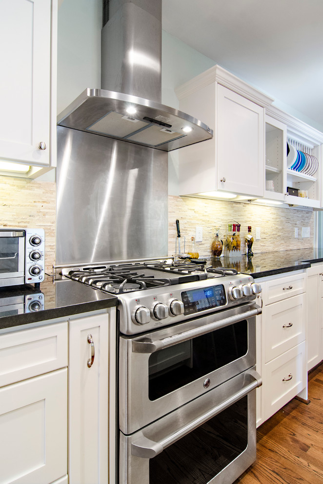 This is an example of a medium sized traditional kitchen/diner in Dallas with a submerged sink, shaker cabinets, white cabinets, granite worktops, brown splashback, stainless steel appliances and medium hardwood flooring.