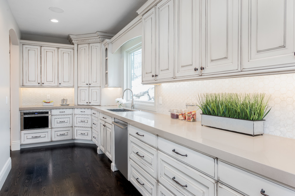 Kitchen - traditional kitchen idea in Salt Lake City with raised-panel cabinets, white cabinets, quartzite countertops and an island