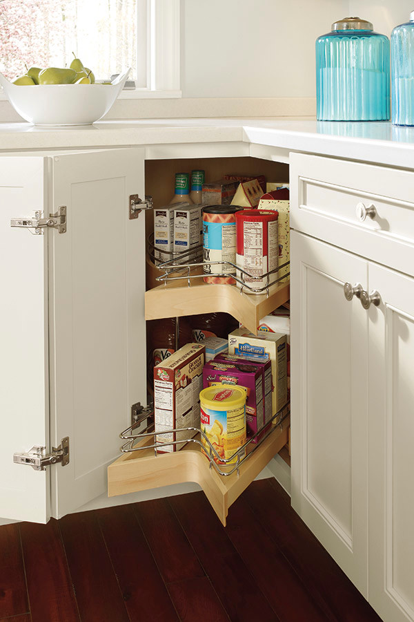 Example of a classic kitchen pantry design with white cabinets, stainless steel appliances, an island and white countertops