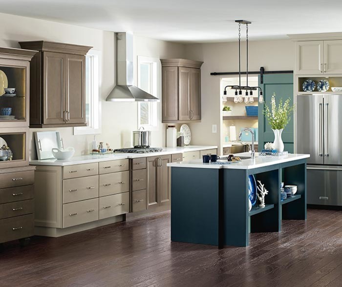 Example of a transitional l-shaped dark wood floor and brown floor eat-in kitchen design with beige cabinets, stainless steel appliances and an island