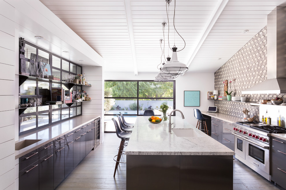 Inspiration for a large mid-century modern galley kitchen remodel in Los Angeles with an undermount sink, flat-panel cabinets, gray cabinets, multicolored backsplash, stainless steel appliances and an island