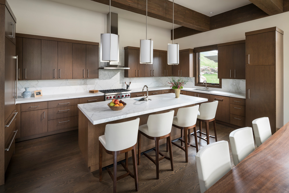 Trendy u-shaped medium tone wood floor and brown floor eat-in kitchen photo in Other with an undermount sink, flat-panel cabinets, medium tone wood cabinets, white backsplash, stone slab backsplash, paneled appliances, an island and white countertops