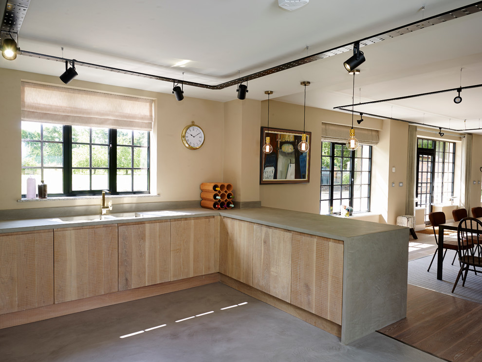 Photo of an industrial u-shaped open plan kitchen in Other with a double-bowl sink, flat-panel cabinets, light wood cabinets, concrete worktops, white splashback, ceramic splashback, stainless steel appliances, concrete flooring and a breakfast bar.