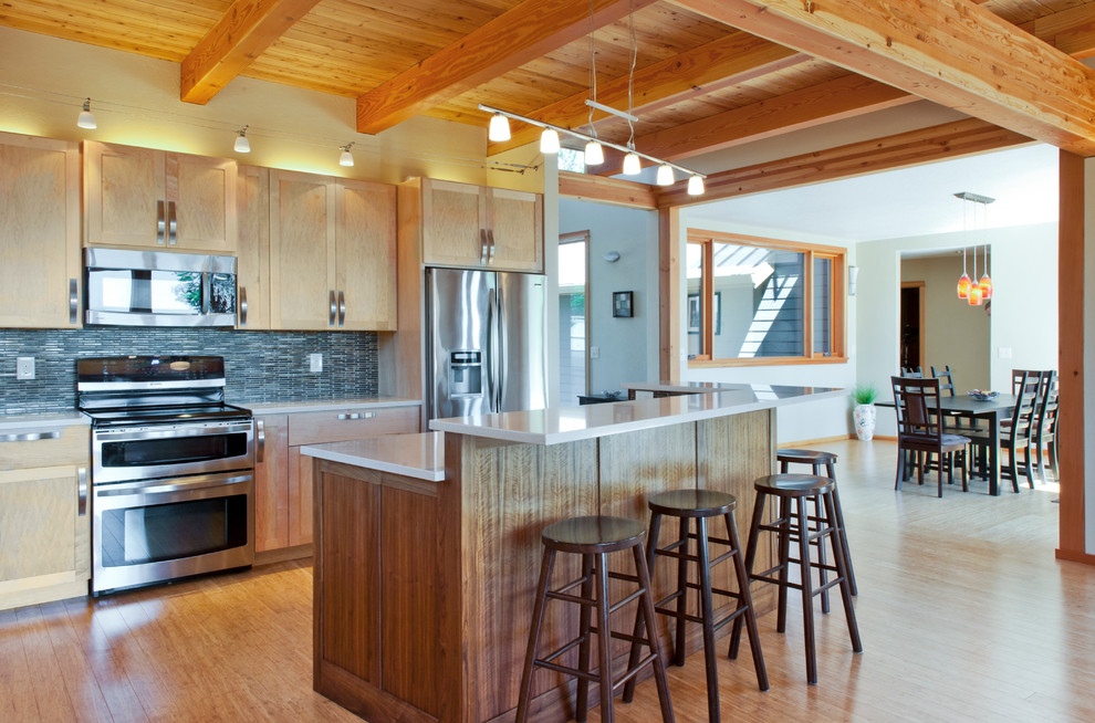 Large arts and crafts l-shaped bamboo floor eat-in kitchen photo in Other with shaker cabinets, quartz countertops, stainless steel appliances, an island, an undermount sink, light wood cabinets, blue backsplash and matchstick tile backsplash