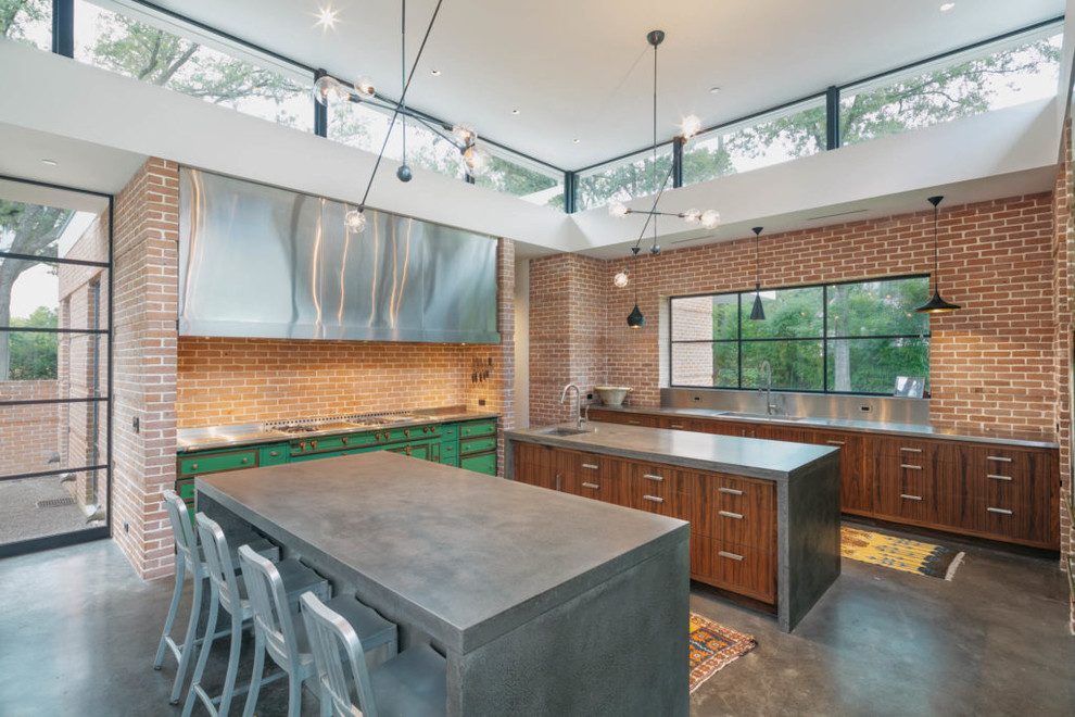 Mid-sized urban l-shaped concrete floor and gray floor open concept kitchen photo in Austin with an undermount sink, flat-panel cabinets, dark wood cabinets, concrete countertops, beige backsplash, brick backsplash, colored appliances and an island
