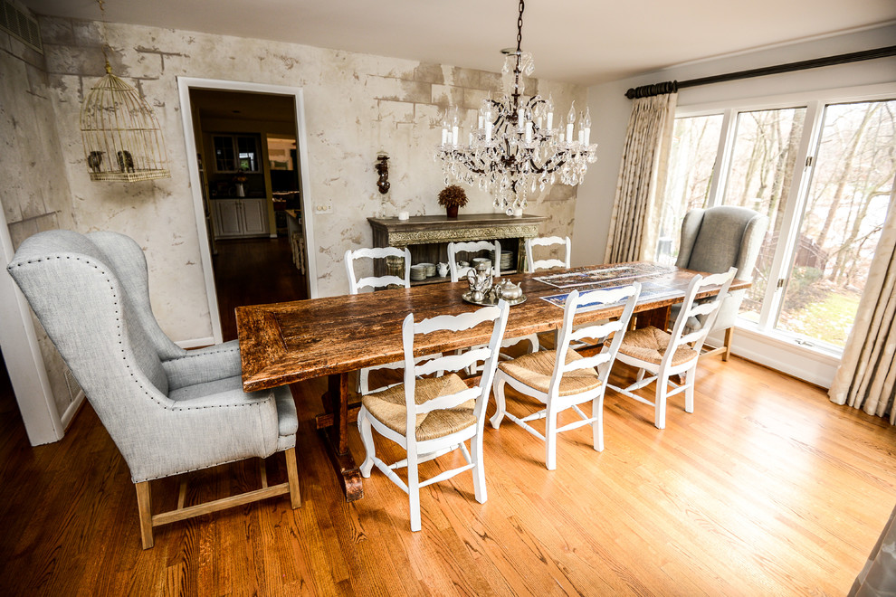 Foto di una sala da pranzo aperta verso la cucina eclettica con pavimento in legno massello medio