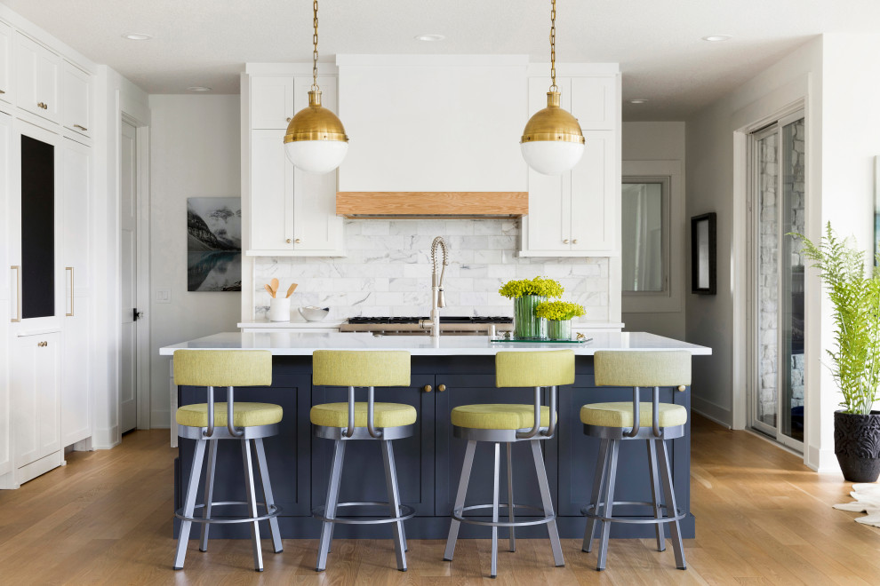 Example of a mid-sized transitional galley beige floor open concept kitchen design in Minneapolis with an undermount sink, white cabinets, gray backsplash, ceramic backsplash, paneled appliances, an island and white countertops