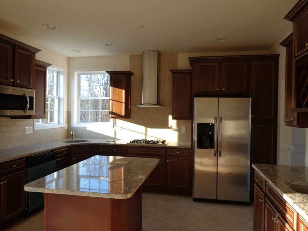 Mid-sized elegant l-shaped ceramic tile and beige floor eat-in kitchen photo in Baltimore with an undermount sink, recessed-panel cabinets, dark wood cabinets, granite countertops, beige backsplash, ceramic backsplash, stainless steel appliances and an island