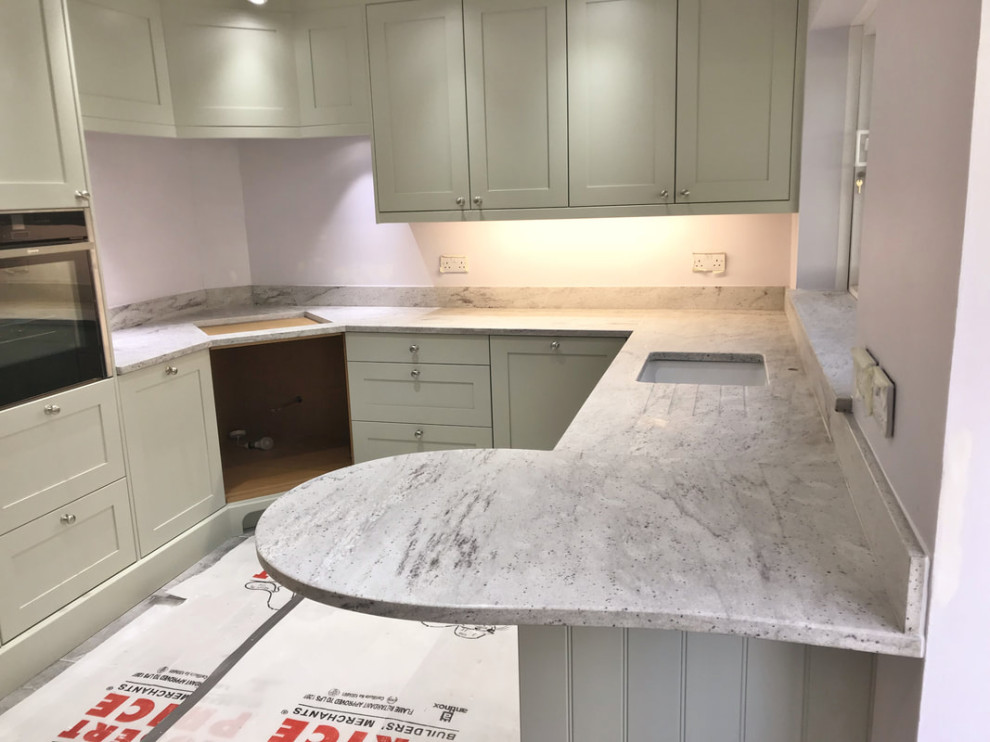 Photo of a farmhouse kitchen in London with granite worktops and white worktops.