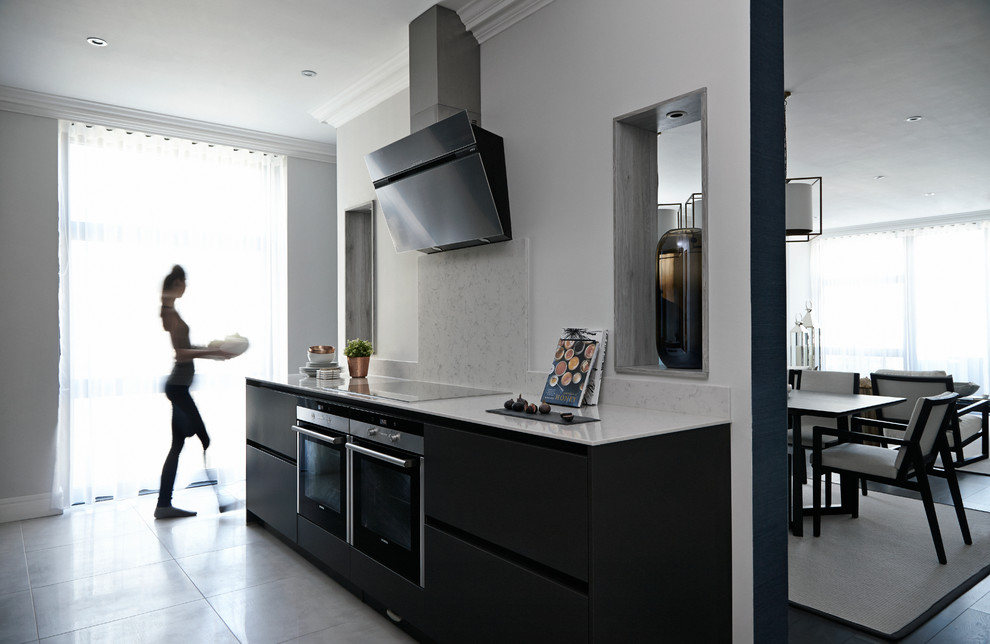 This is an example of a contemporary grey and cream kitchen in London.