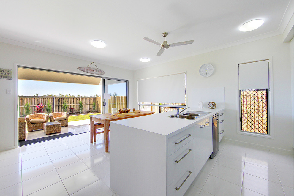 Inspiration for a contemporary kitchen in Townsville with a built-in sink, white cabinets and stainless steel appliances.