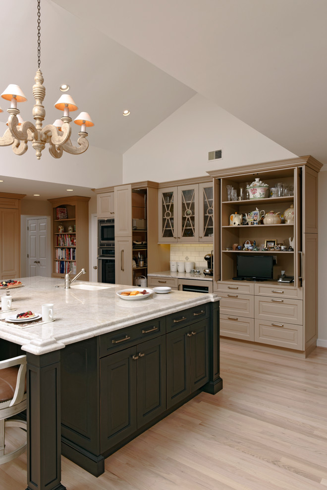 Inspiration for an expansive classic l-shaped kitchen/diner in DC Metro with a submerged sink, raised-panel cabinets, beige cabinets, granite worktops, beige splashback, ceramic splashback, stainless steel appliances, light hardwood flooring and an island.