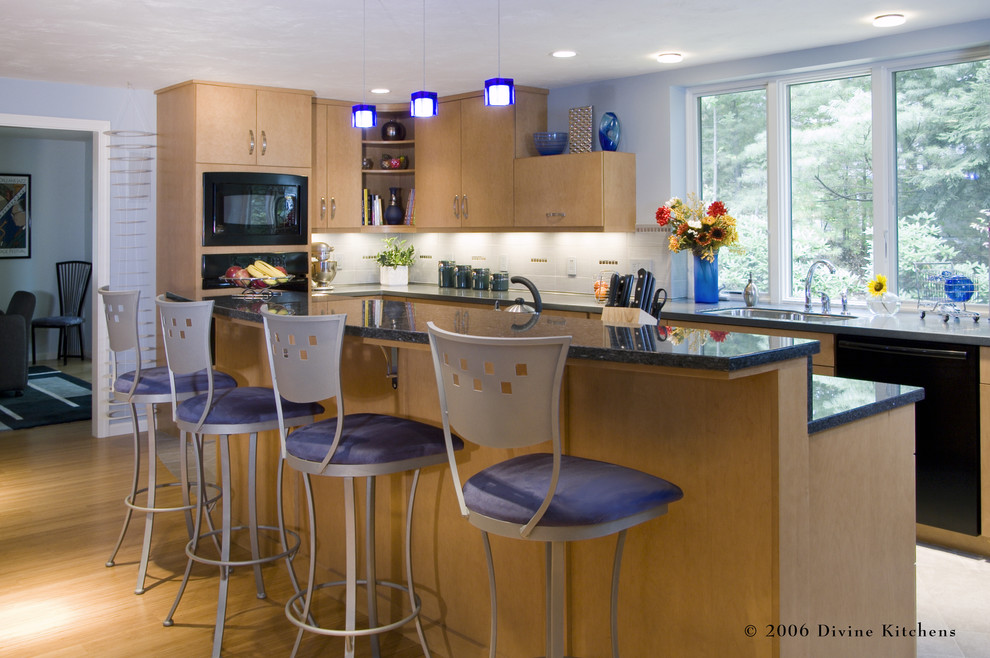 Eat-in kitchen - large contemporary l-shaped light wood floor eat-in kitchen idea in Boston with an undermount sink, flat-panel cabinets, light wood cabinets, granite countertops, white backsplash, ceramic backsplash, black appliances and an island
