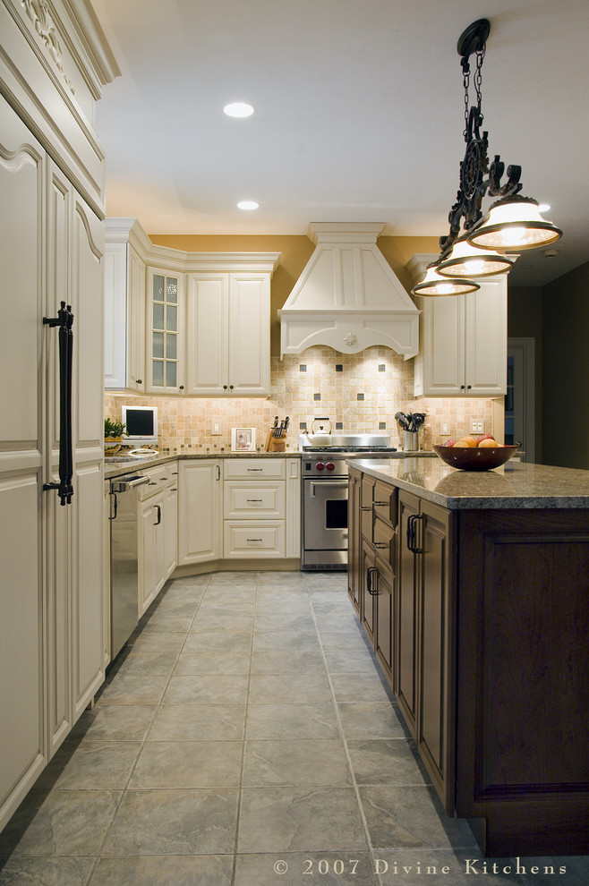 Example of a large classic u-shaped porcelain tile eat-in kitchen design in Boston with an undermount sink, beaded inset cabinets, white cabinets, granite countertops, beige backsplash, stone tile backsplash, stainless steel appliances and an island