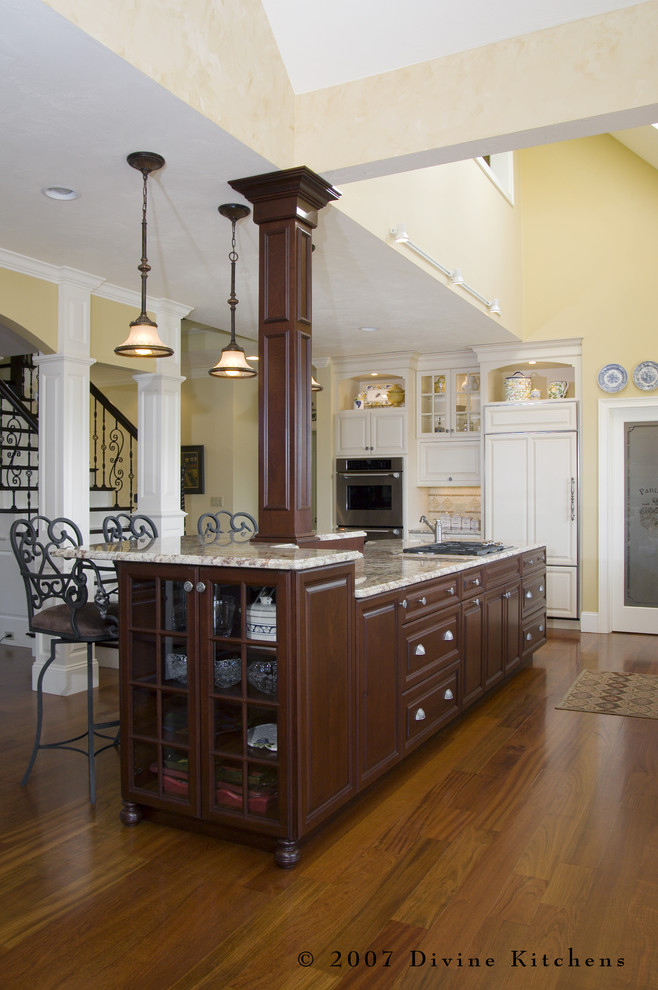 Example of a large classic l-shaped dark wood floor eat-in kitchen design in Boston with a double-bowl sink, beaded inset cabinets, dark wood cabinets, granite countertops, beige backsplash, ceramic backsplash, stainless steel appliances and an island