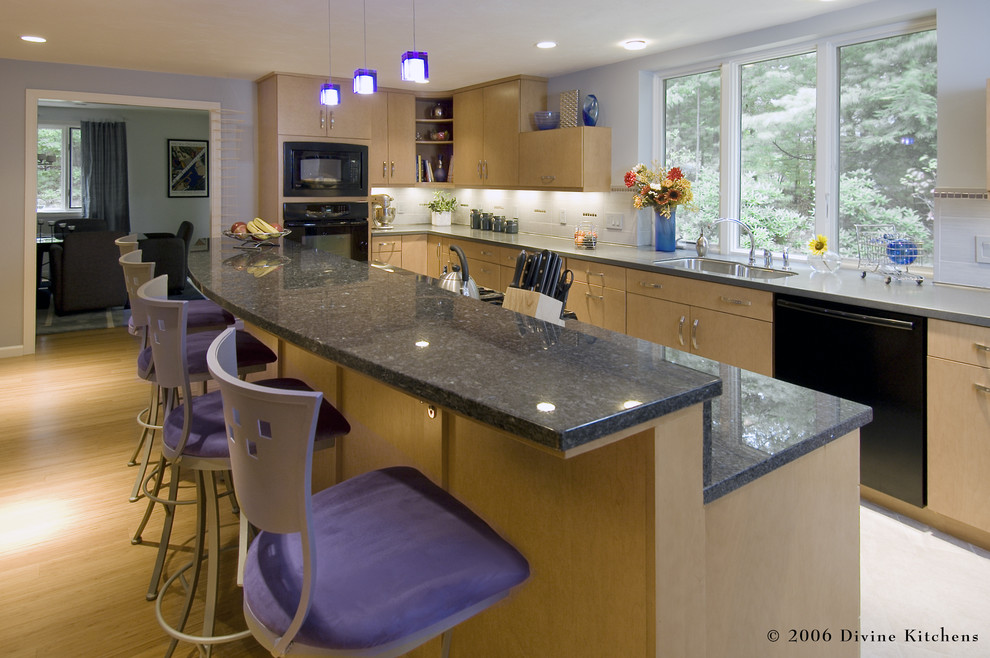 Example of a large trendy l-shaped light wood floor eat-in kitchen design in Boston with an undermount sink, flat-panel cabinets, light wood cabinets, granite countertops, white backsplash, ceramic backsplash, black appliances and an island