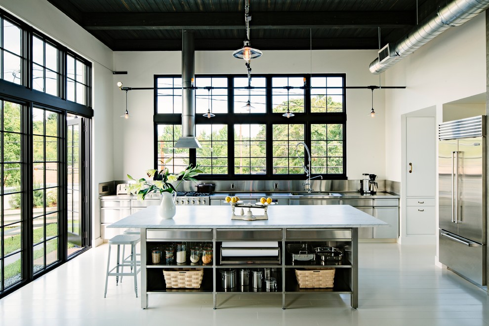 Urban kitchen photo in Portland with an integrated sink, stainless steel cabinets, metallic backsplash, metal backsplash, stainless steel appliances, marble countertops and flat-panel cabinets