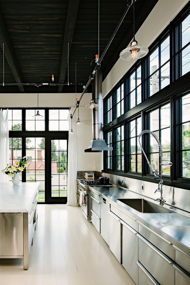 Inspiration for an industrial single-wall kitchen in Portland with an integrated sink, stainless steel cabinets, stainless steel worktops, metallic splashback, metal splashback and stainless steel appliances.