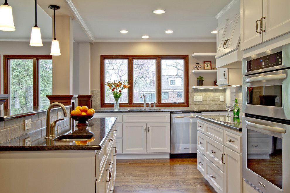 Photo of a traditional kitchen in Salt Lake City with recessed-panel cabinets, white cabinets, granite worktops and stainless steel appliances.