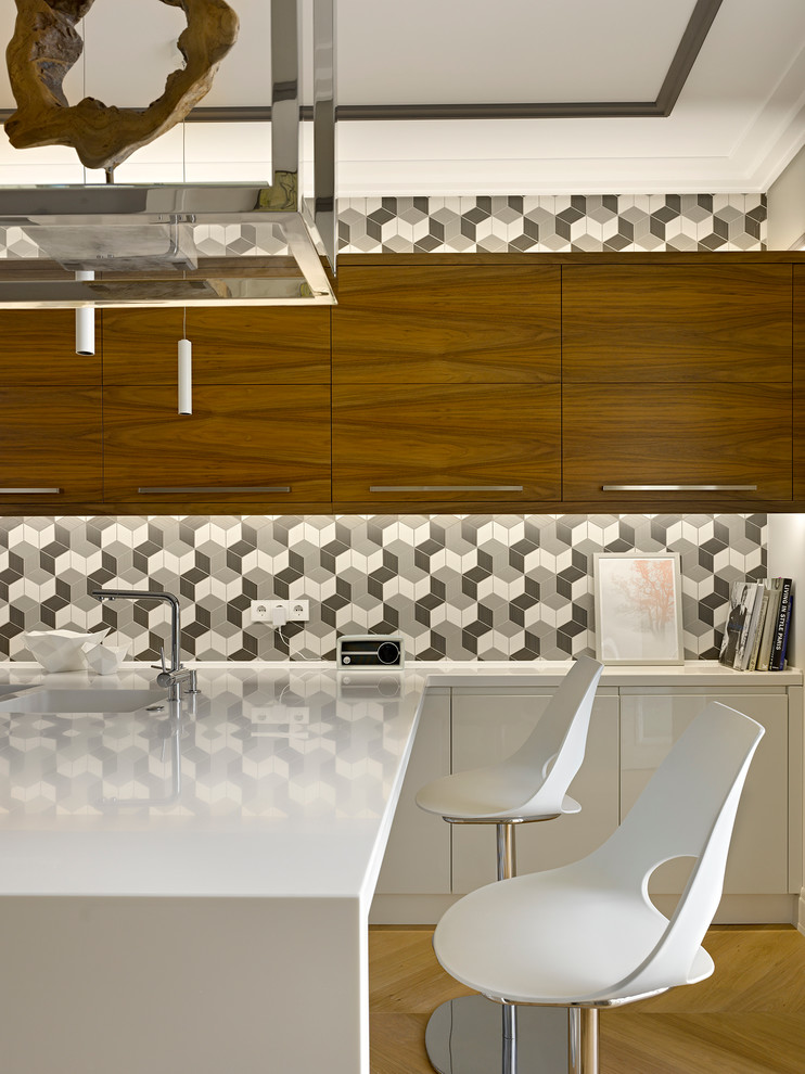 Inspiration for a contemporary u-shaped light wood floor open concept kitchen remodel in Moscow with an integrated sink, flat-panel cabinets, white cabinets, solid surface countertops, multicolored backsplash, ceramic backsplash, black appliances and a peninsula