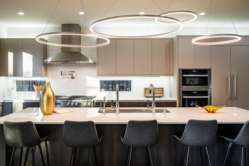 Contemporary kitchen in Seattle with a submerged sink, quartz worktops, white splashback, porcelain splashback, stainless steel appliances, an island, white worktops, flat-panel cabinets and brown cabinets.