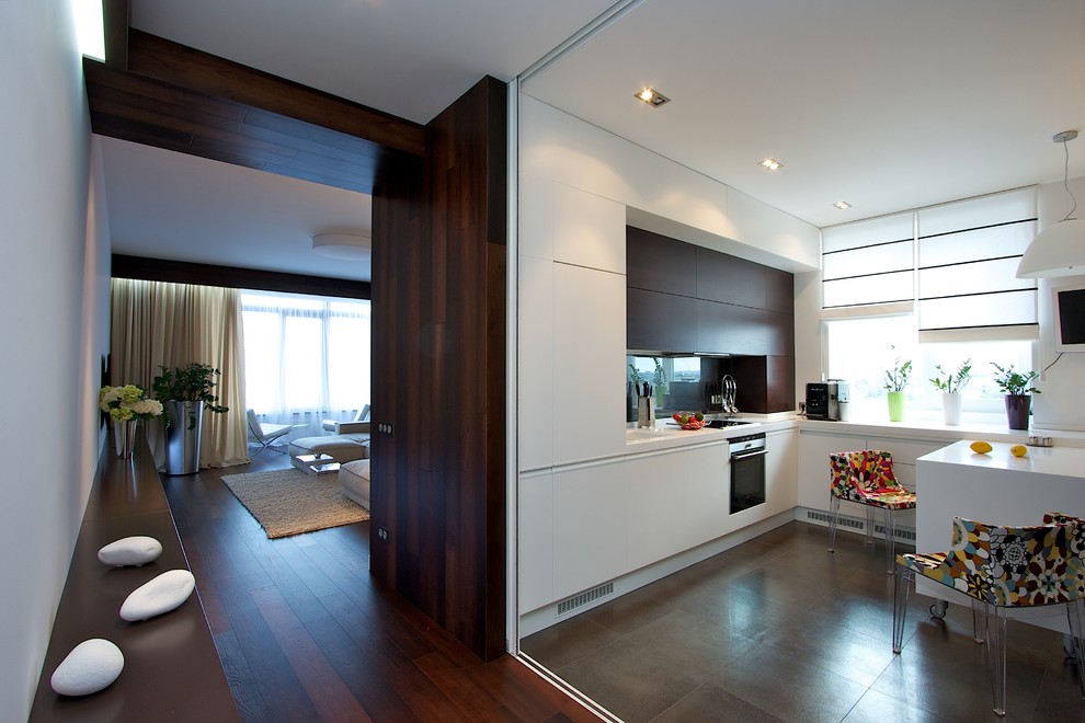 Inspiration for a contemporary kitchen remodel with flat-panel cabinets, white cabinets and stainless steel appliances