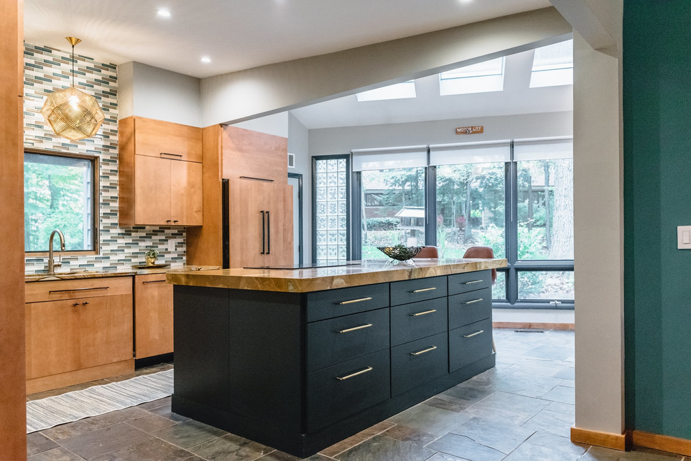 Eat-in kitchen - mid-sized 1960s l-shaped slate floor and multicolored floor eat-in kitchen idea in Detroit with a single-bowl sink, flat-panel cabinets, medium tone wood cabinets, quartzite countertops, multicolored backsplash, ceramic backsplash, black appliances and an island