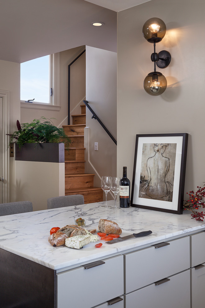 Eat-in kitchen - modern l-shaped medium tone wood floor eat-in kitchen idea in San Francisco with an undermount sink, flat-panel cabinets, gray cabinets, marble countertops, black backsplash, matchstick tile backsplash, stainless steel appliances and a peninsula