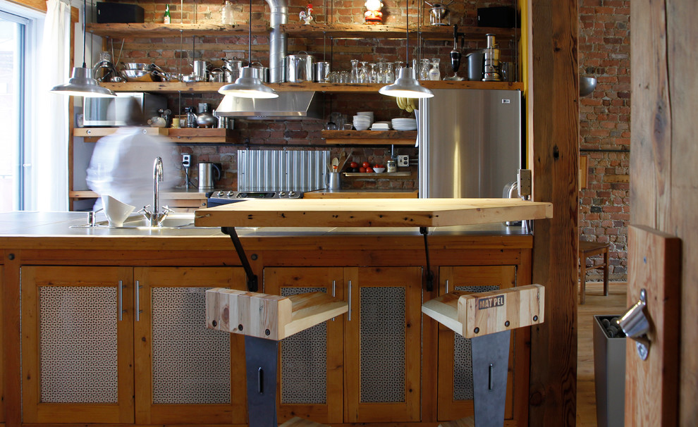 Inspiration for an industrial kitchen in Montreal with stainless steel appliances.