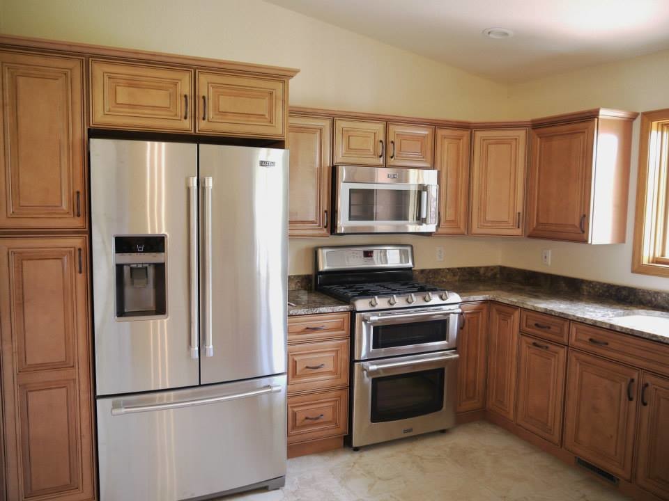 Photo of a medium sized classic u-shaped kitchen/diner in Grand Rapids with a submerged sink, raised-panel cabinets, medium wood cabinets, granite worktops, stainless steel appliances and a breakfast bar.
