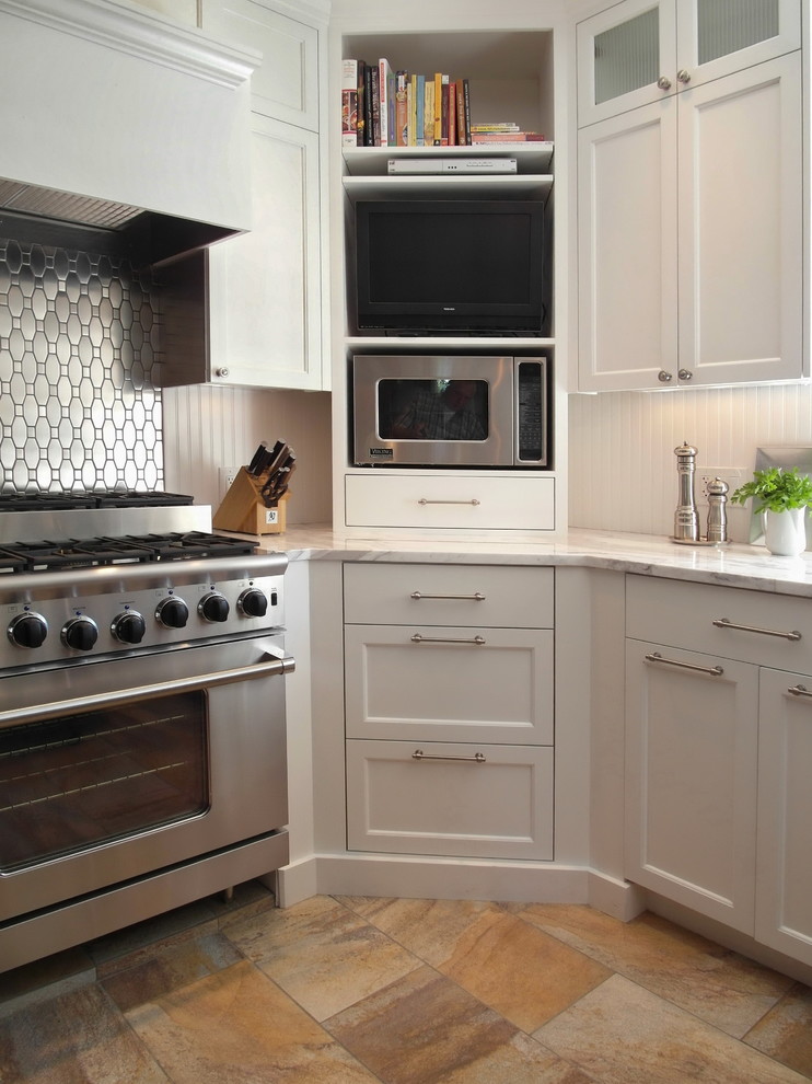 Inspiration for a transitional kitchen remodel in Portland with recessed-panel cabinets, white cabinets, metallic backsplash, metal backsplash and stainless steel appliances