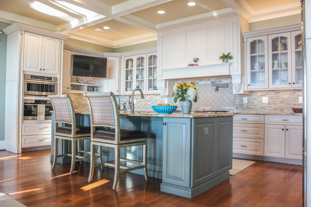 Eat-in kitchen - huge traditional u-shaped dark wood floor eat-in kitchen idea in DC Metro with an undermount sink, raised-panel cabinets, white cabinets, granite countertops, multicolored backsplash, ceramic backsplash, stainless steel appliances and an island