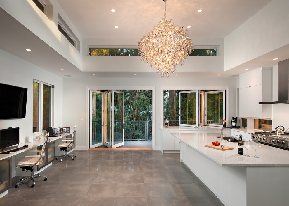 Large contemporary u-shaped open plan kitchen in Vancouver with a submerged sink, flat-panel cabinets, white cabinets, marble worktops, stainless steel appliances, concrete flooring and an island.
