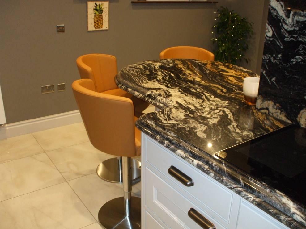 Design ideas for a contemporary kitchen/diner in Other with granite worktops, a breakfast bar and multicoloured worktops.