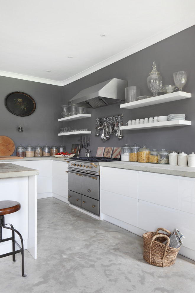 Inspiration for a farmhouse grey and white kitchen in Dorset with flat-panel cabinets, white cabinets and an island.
