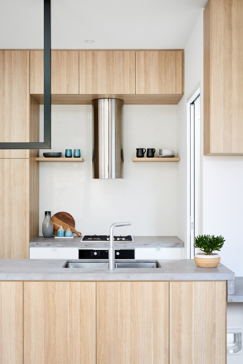 Experience Modern Simplicity with Light Wood Kitchen Cabinets and Concrete Countertops