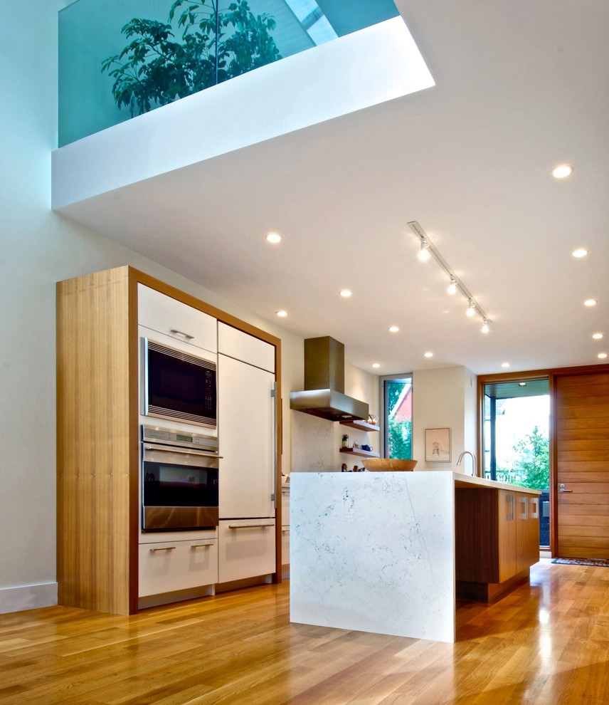 Photo of a modern kitchen in Toronto with marble worktops and integrated appliances.