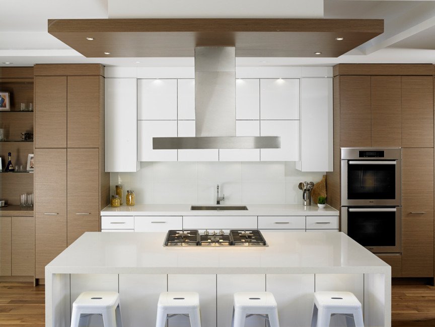 Eat-in kitchen - modern medium tone wood floor eat-in kitchen idea in Toronto with flat-panel cabinets, white backsplash, glass tile backsplash, stainless steel appliances, an island, an undermount sink, medium tone wood cabinets and quartz countertops