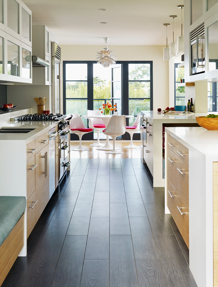 This is an example of a medium sized contemporary galley open plan kitchen in San Francisco with light wood cabinets, flat-panel cabinets, grey splashback, stainless steel appliances, metro tiled splashback, a double-bowl sink, engineered stone countertops, dark hardwood flooring and an island.