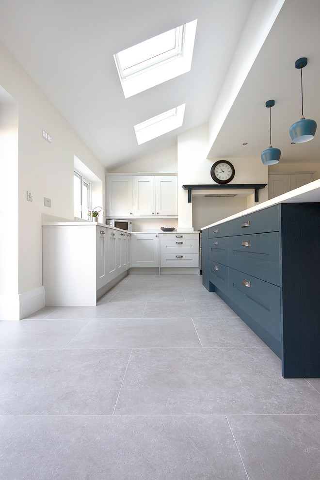 This is an example of a large contemporary l-shaped kitchen/diner in Other with porcelain flooring, an island and grey floors.