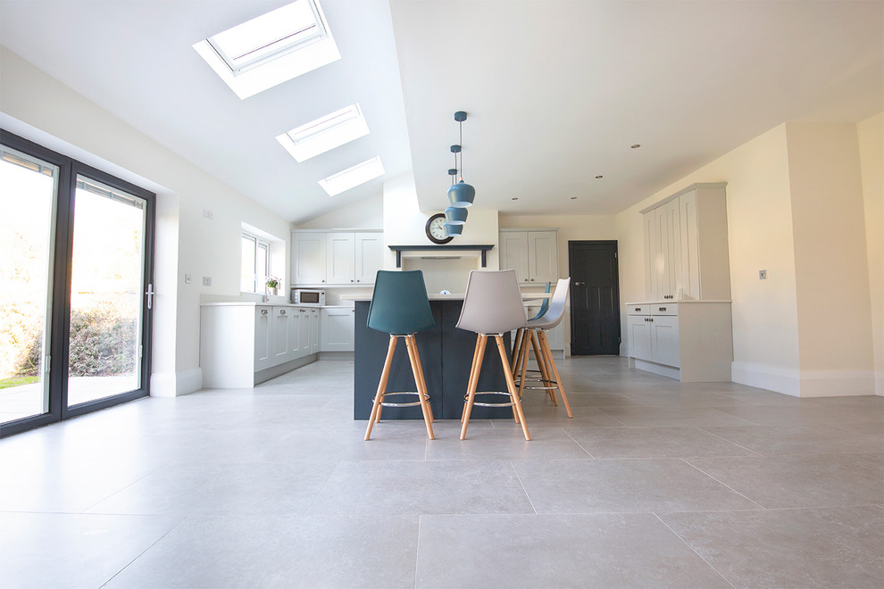 Eat-in kitchen - large contemporary l-shaped porcelain tile and gray floor eat-in kitchen idea in Other with an island