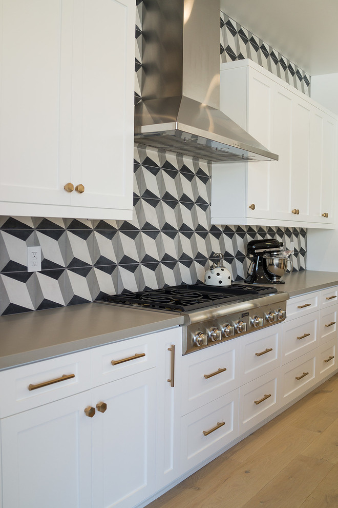 Inspiration for a large contemporary l-shaped light wood floor and white floor eat-in kitchen remodel in Orange County with a single-bowl sink, shaker cabinets, white cabinets, quartz countertops, gray backsplash, cement tile backsplash, stainless steel appliances and an island