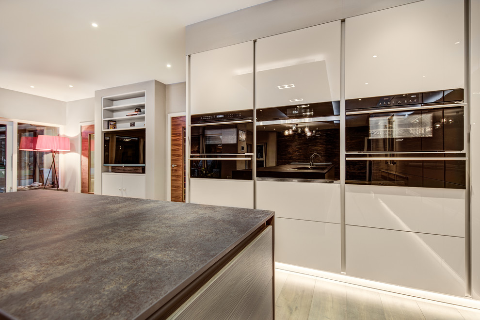 This is an example of a contemporary kitchen in Hampshire.