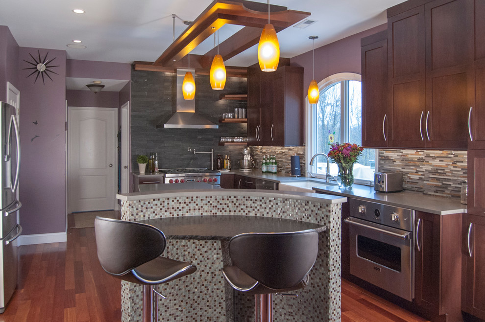 Eat-in kitchen - mid-sized l-shaped medium tone wood floor eat-in kitchen idea in Philadelphia with a farmhouse sink, shaker cabinets, dark wood cabinets, quartz countertops, multicolored backsplash, stainless steel appliances and an island