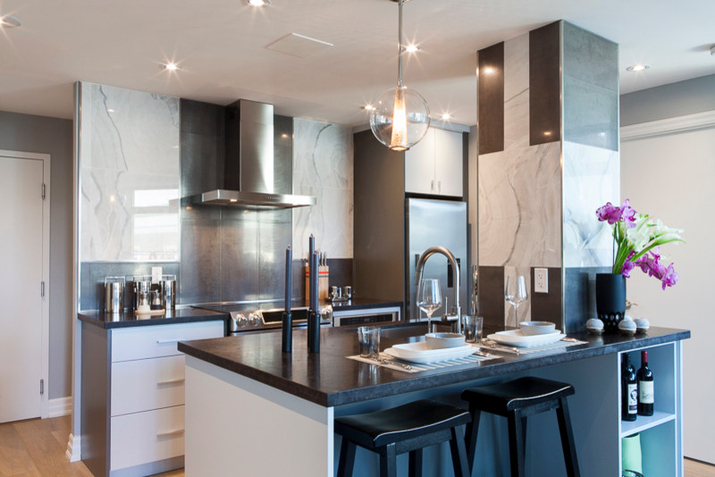 Eat-in kitchen - small modern galley light wood floor eat-in kitchen idea in Toronto with a single-bowl sink, flat-panel cabinets, gray cabinets, wood countertops, metallic backsplash, ceramic backsplash, stainless steel appliances and an island